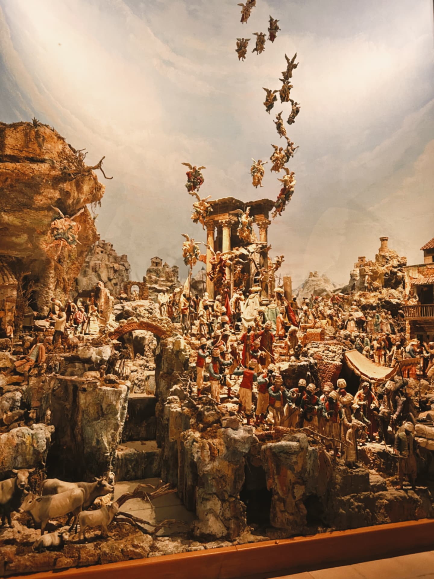 a large nativity scene with angels among painted ruins