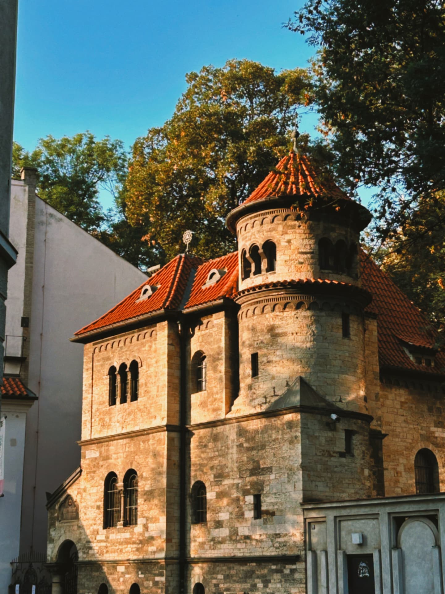 an old stone synagogue with a terracotta roof