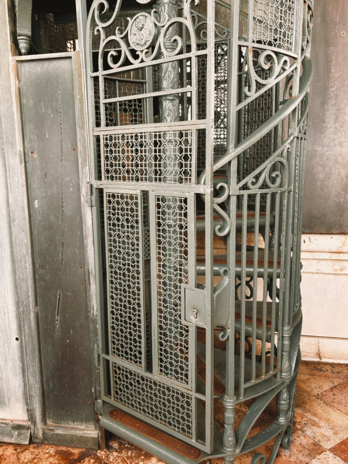 a wrought-iron spiral stair with openwork panels