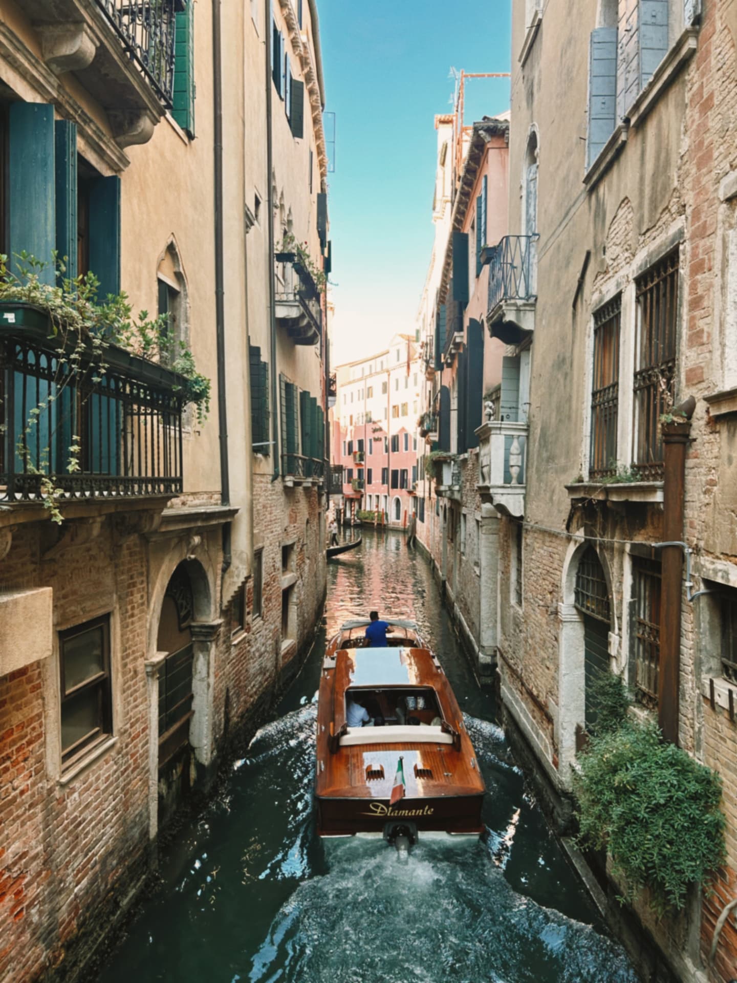 motorboat gliding down a narrow canal