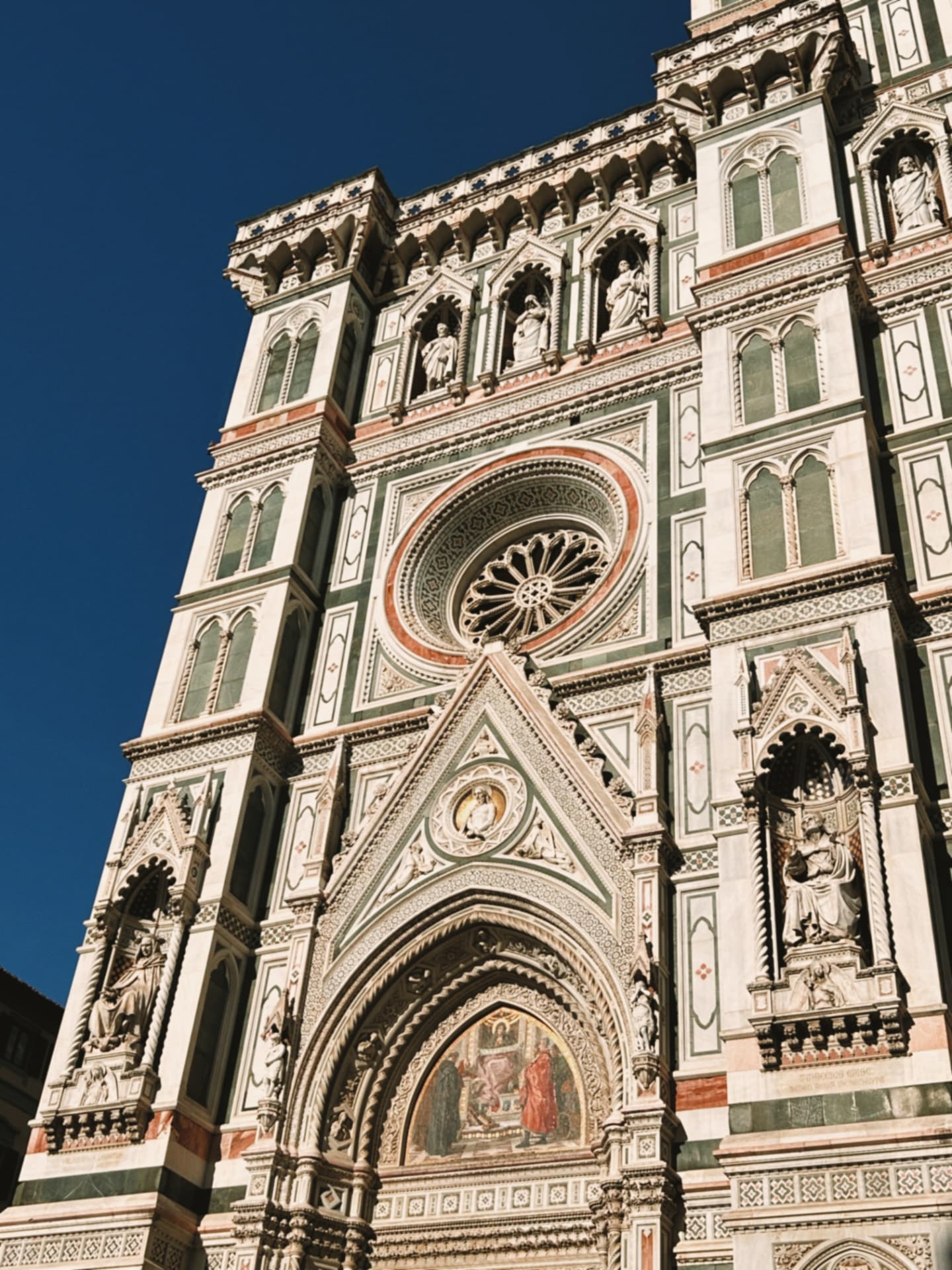 the cathedral facade with rose window and statuary