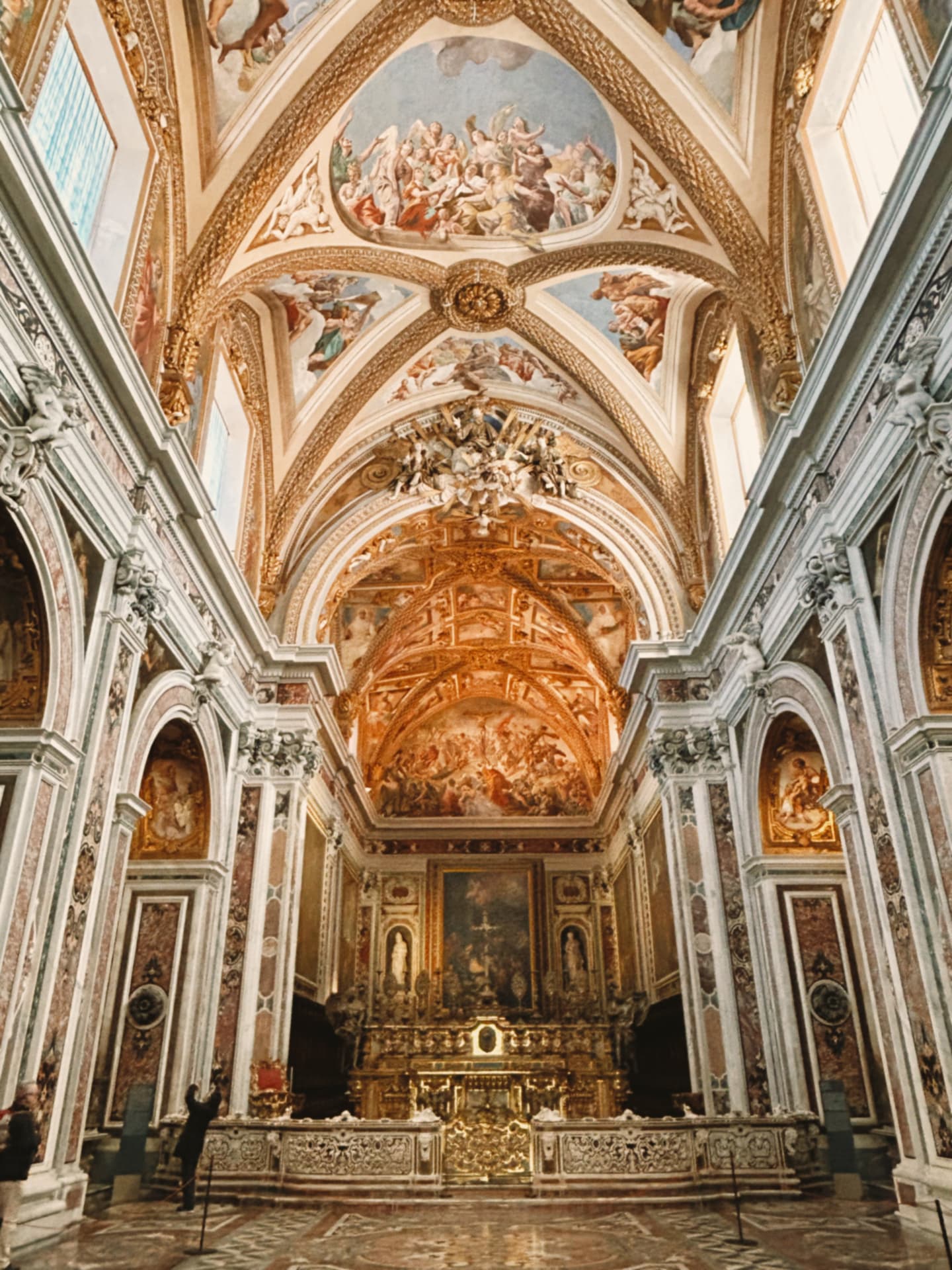 a vaulted church interior with painted murals