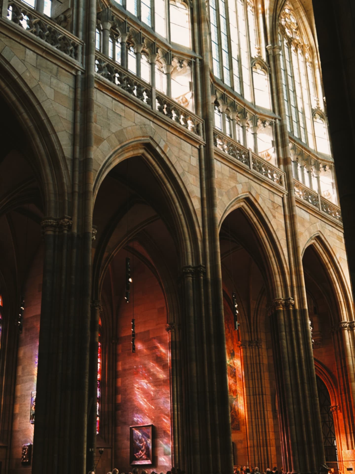a tall Gothic church interior with stained glass