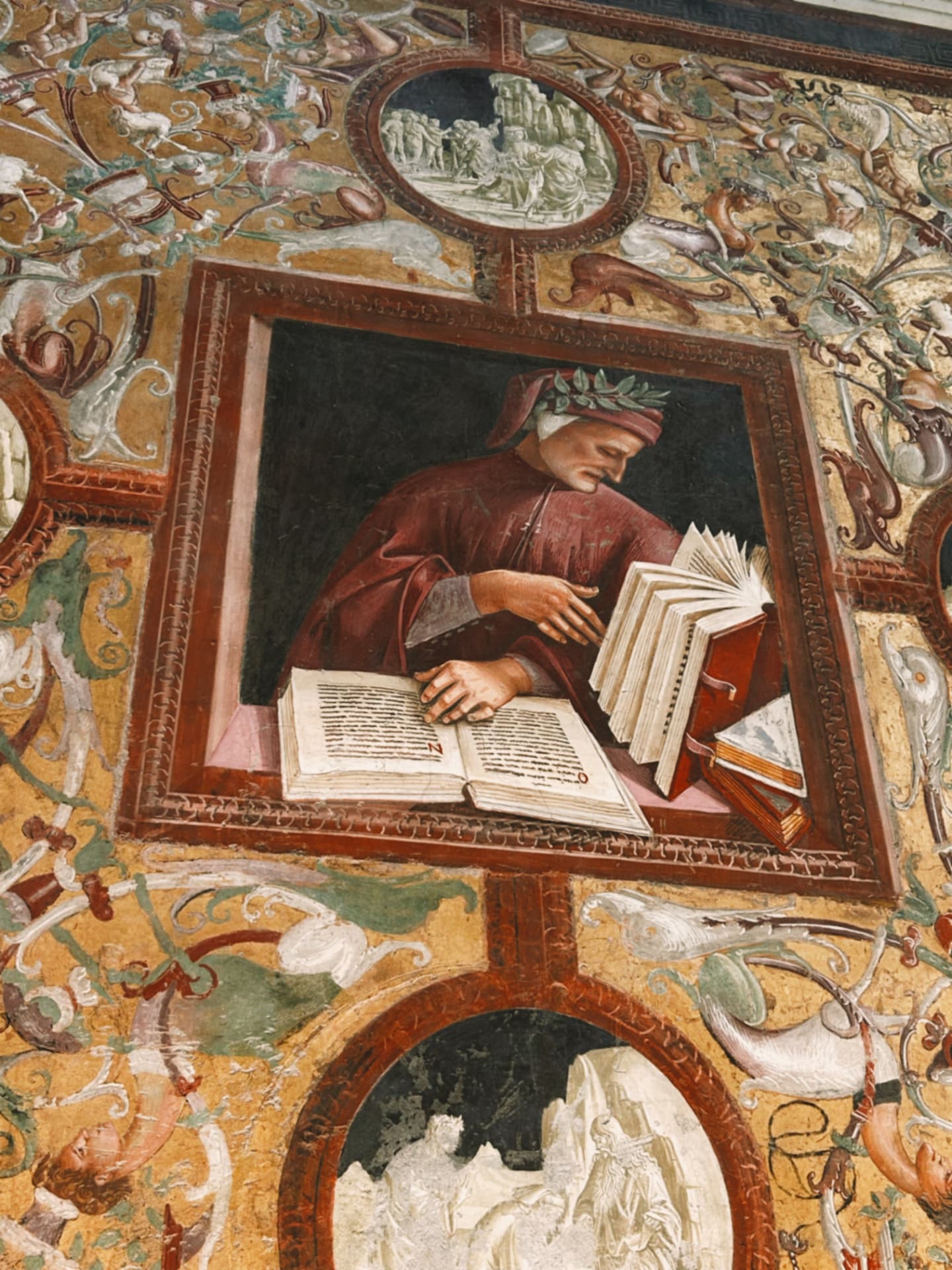 a fresco of a figure reading among painted ornament