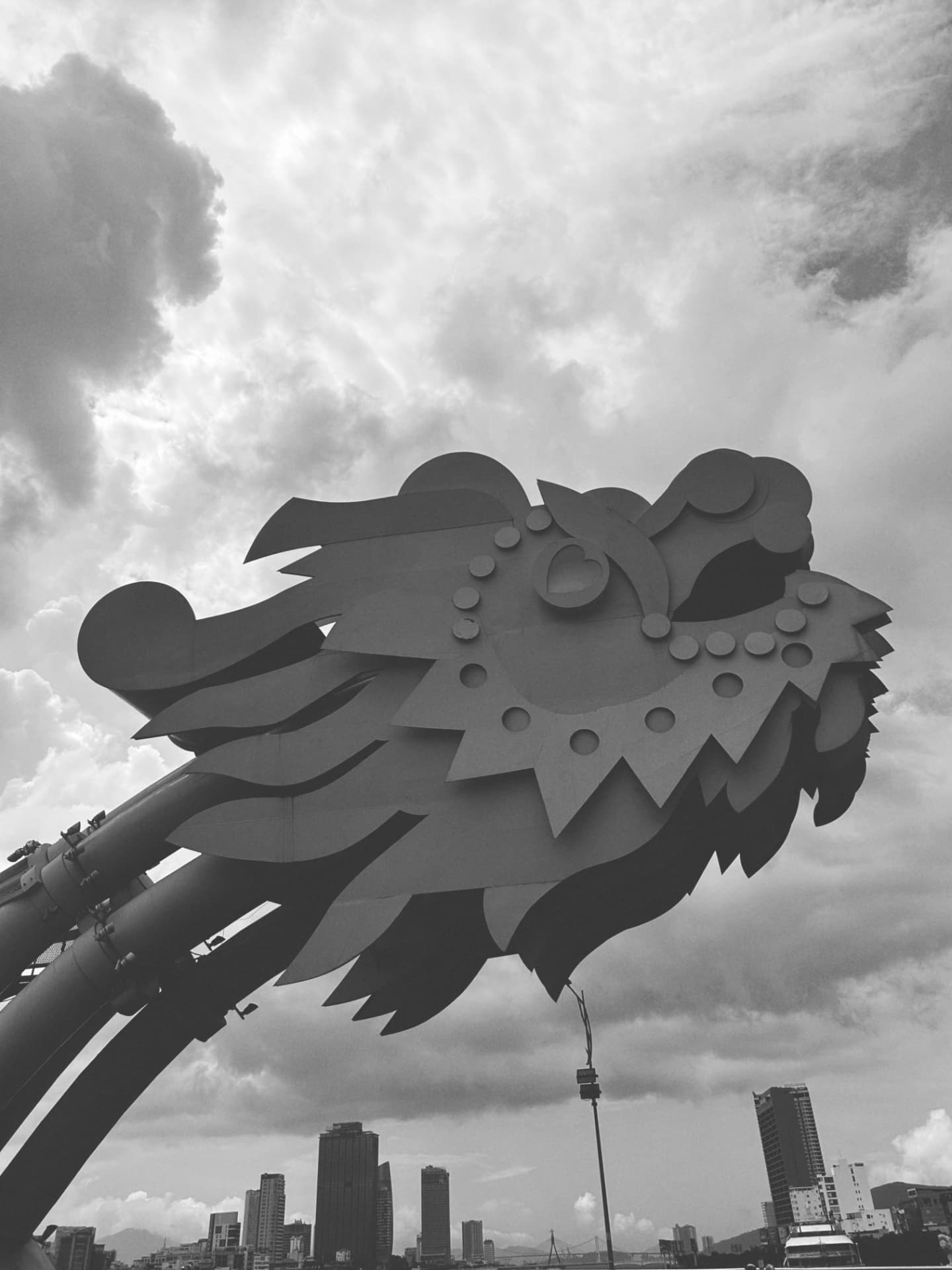 A sculpted bridge head by day beneath a brooding sky