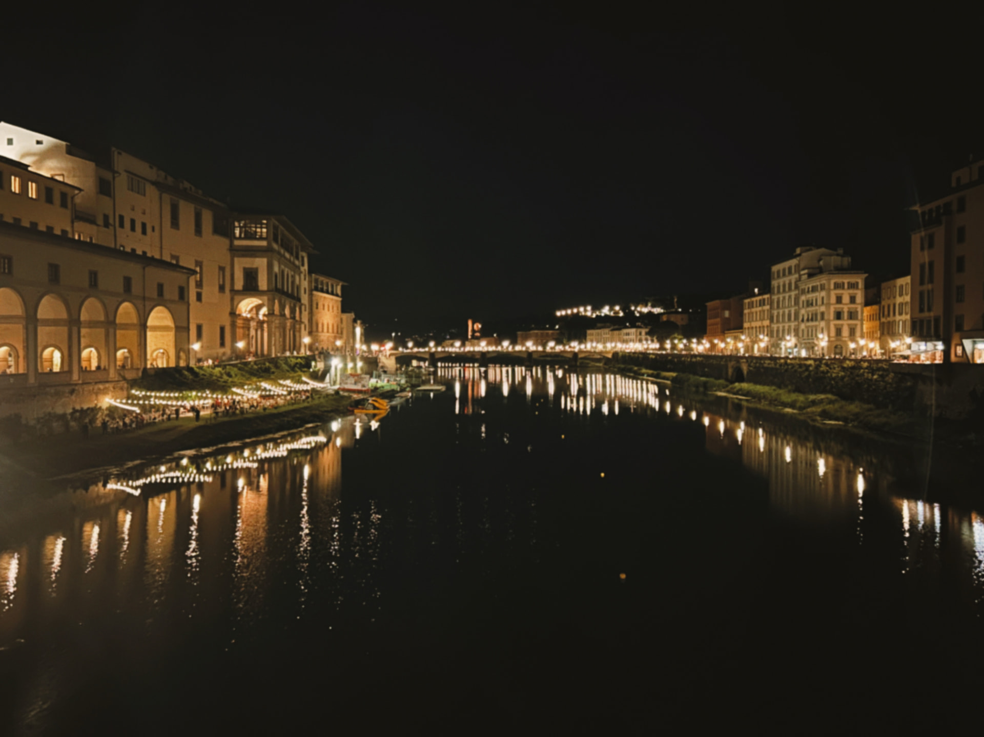 a night river with lights and a bridge