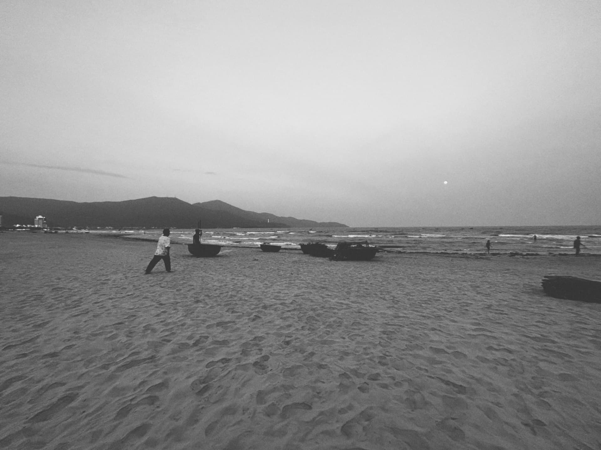 Coracle boats resting on a wide evening beach