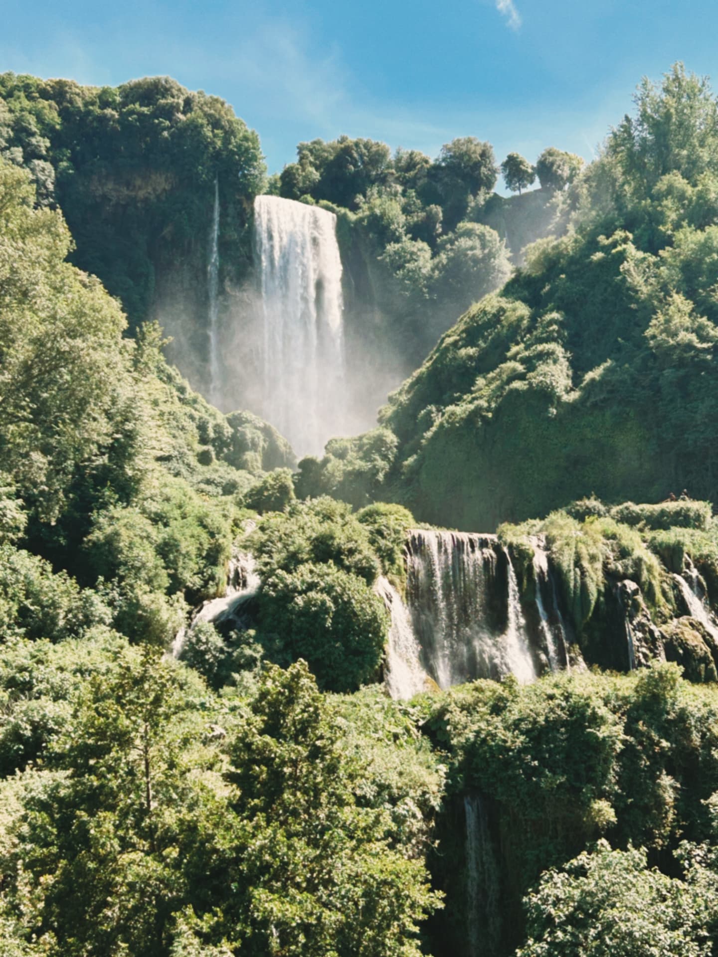 waterfall and cascades in a green gorge