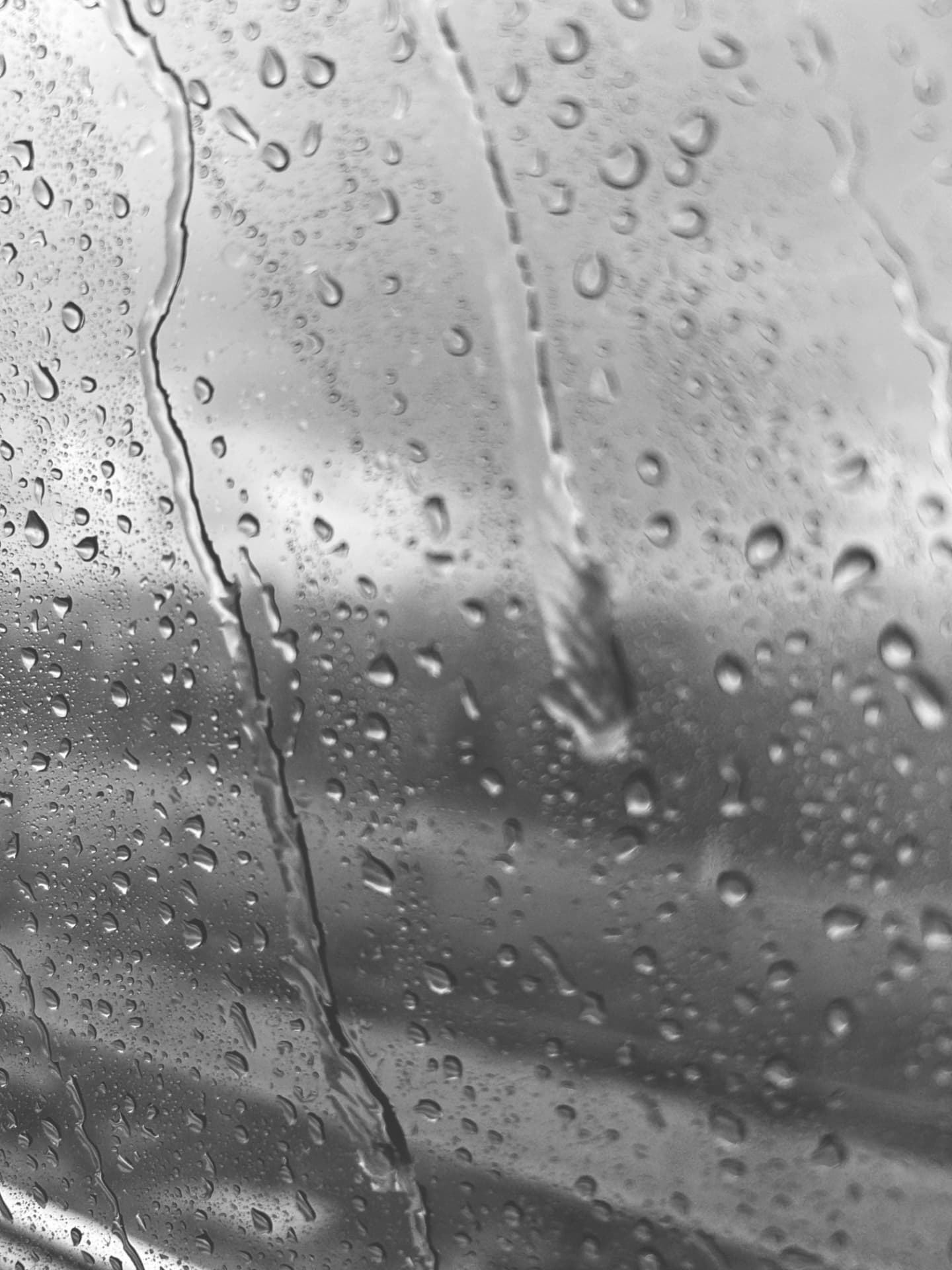 Raindrops running down a window pane