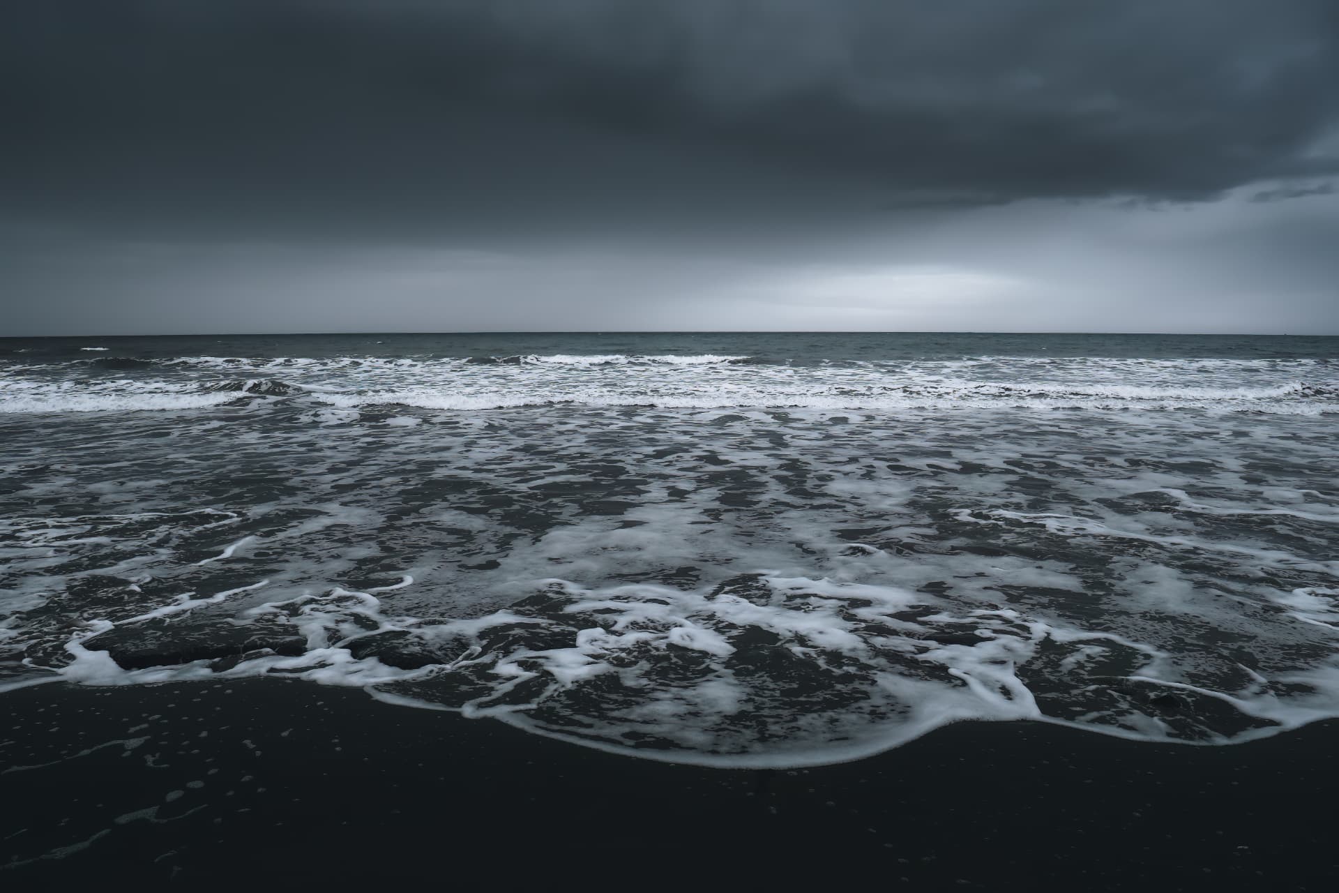Waves rolling under storm clouds