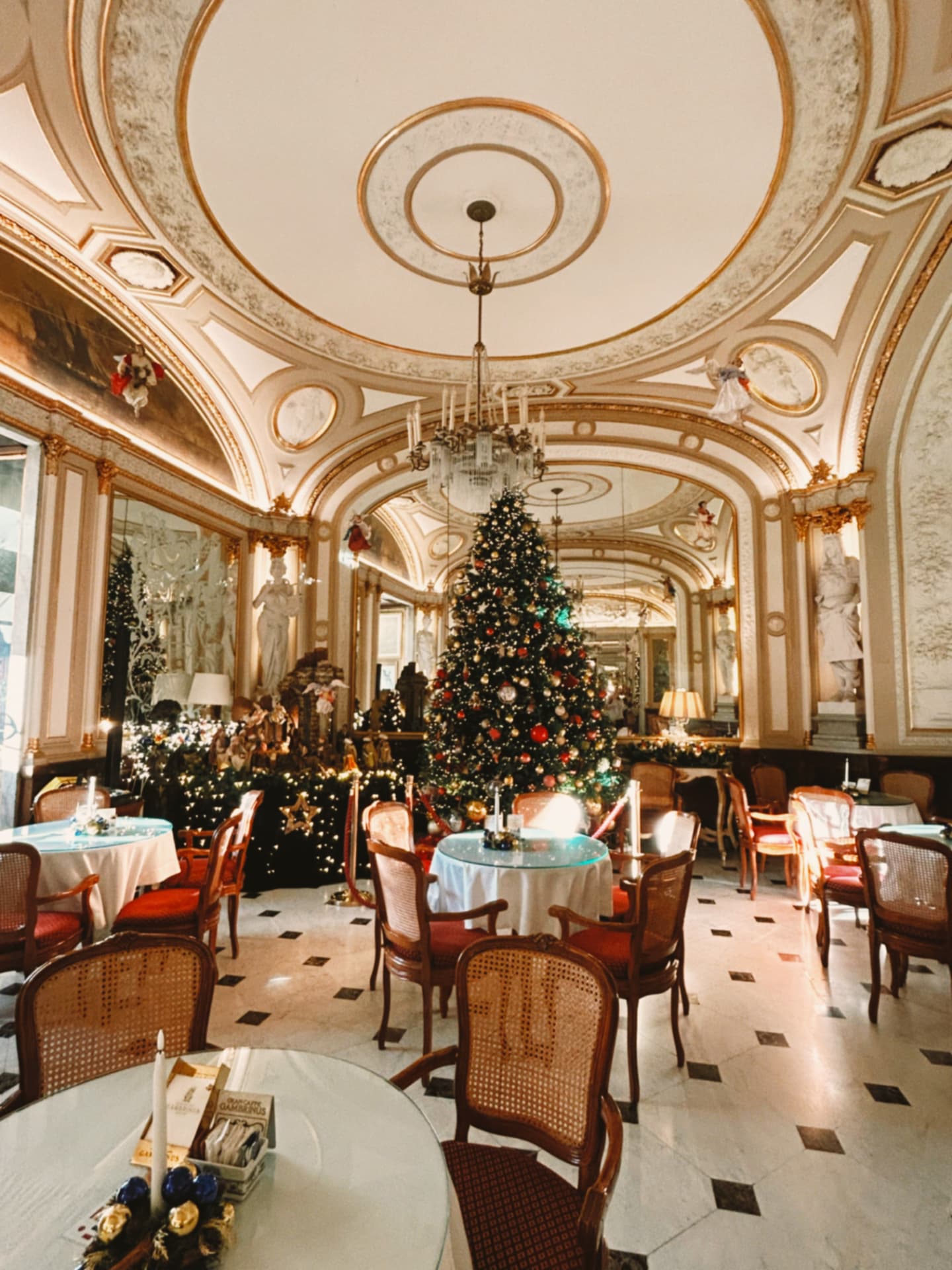 ornate cafe interior with a decorated Christmas tree